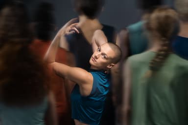 Headshot of Emily with blurry people surrounding her